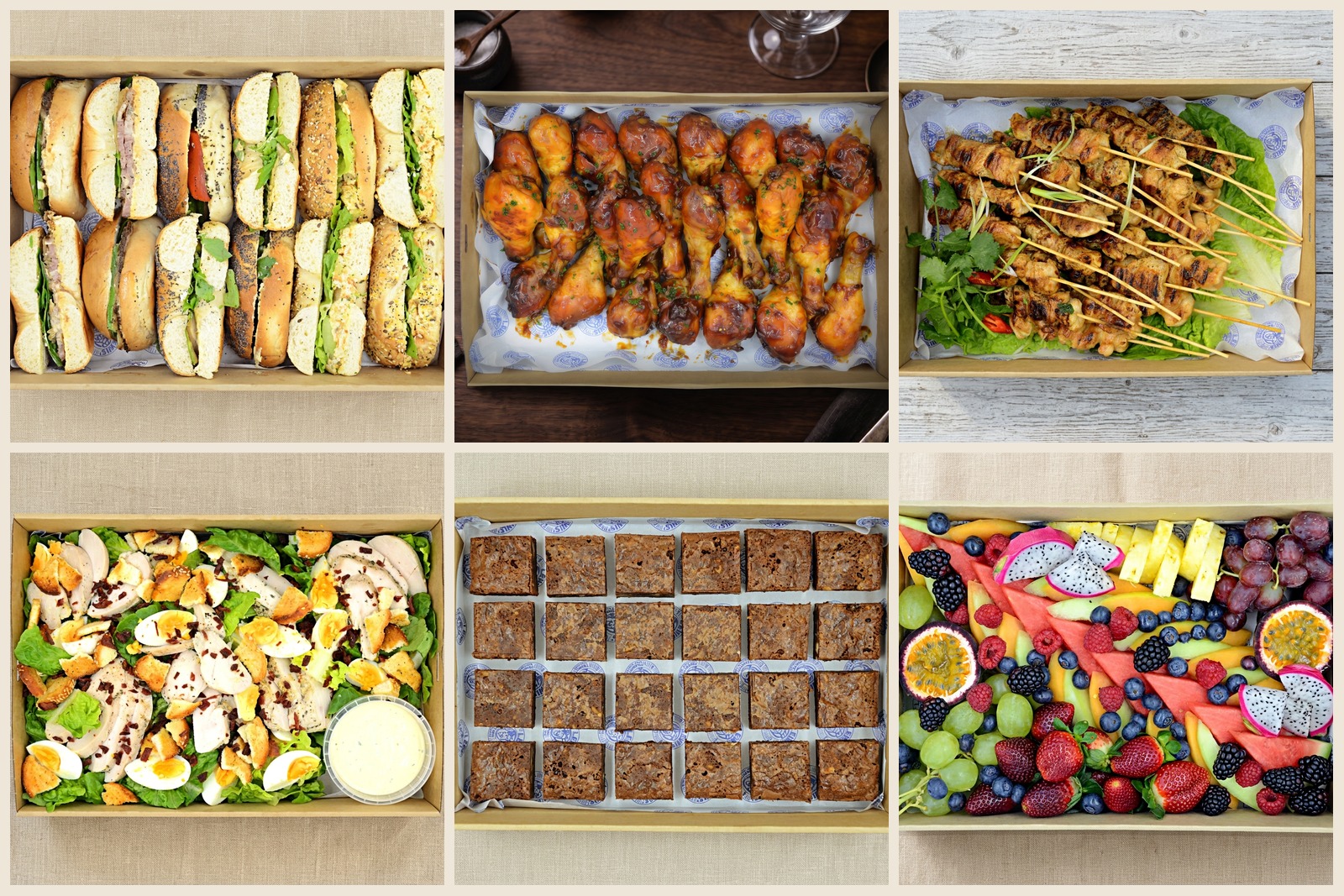 Shared catering spread of sandwiches, skewers, salads and fruit for a group
